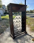 Vintage Wine Rack: Brown Wood Cabinet 24 / 48; Black Metal Art Nouveau 16 Bottle Used. Price: $360.00.